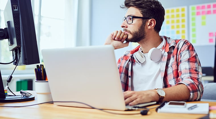 Man at a laptop pondering his ATS