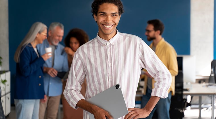 An employee smiles since he's helped his organization strengthen their employee retention with valuable data. 