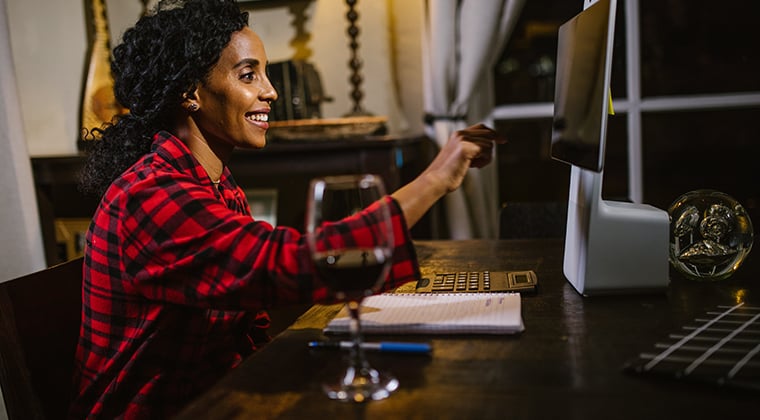 An employer happily reviews a batch of asynchronous video interviews for a role they're filling. 