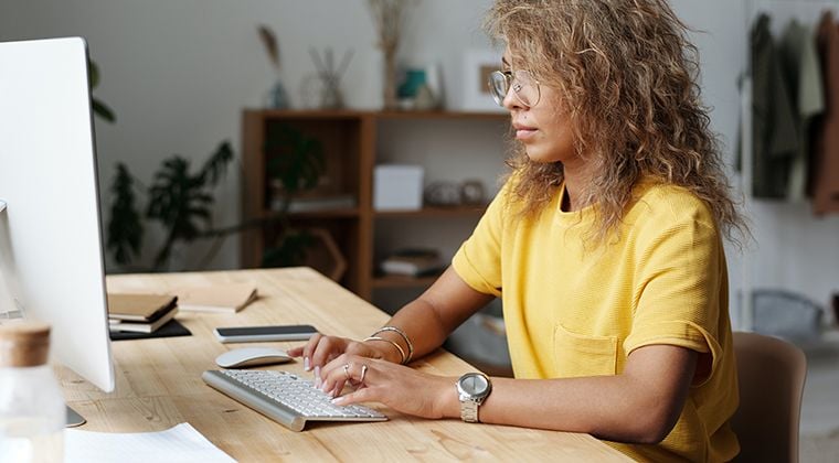 An HR tech employee goes over popular ATS stats on her computer. 