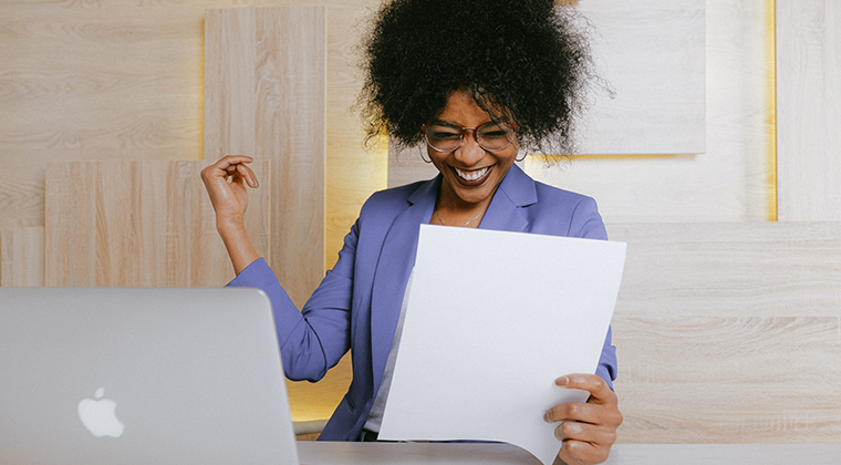 A CEO studies her organization's hiring strategy on her computer. 