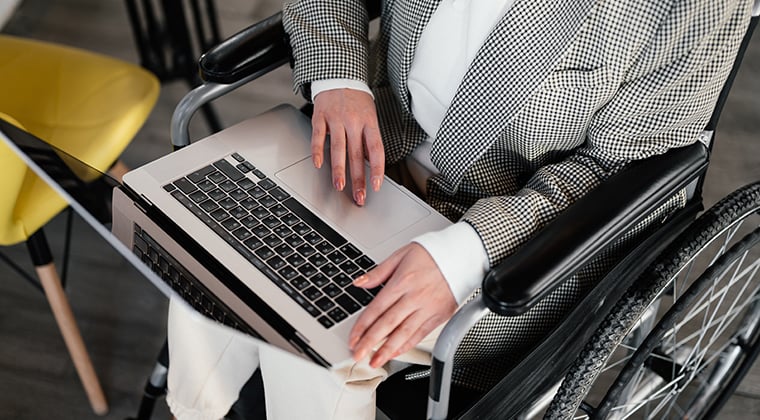 A job candidate looks at a company careers page on their laptop. 