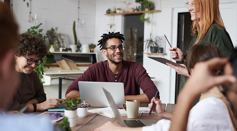 Co-workers meeting around a table